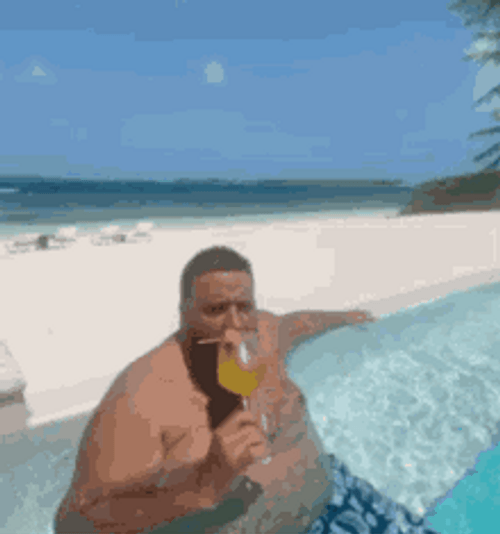 chubby-man-drinking-on-a-beach-k8j86and3opbrfm2.gif